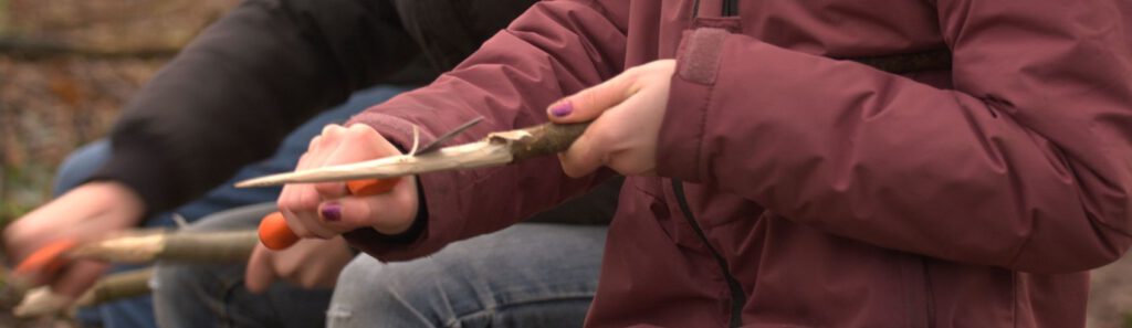 Werken met mes en bijl, essentiƫle outdoor vaardigheden die kinderen moeten leren beheersen tijdens de training bij BosBrein.